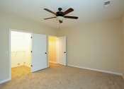 Thumbnail 7 of 18 - a empty living room with a ceiling fan