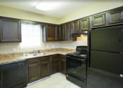 Thumbnail 29 of 29 - a kitchen with a black refrigerator and a sink