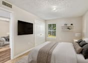 Thumbnail 4 of 9 - a bedroom with a large bed and a flat screen tv