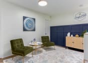 Thumbnail 11 of 24 - a living room with two green chairs and a coffee table