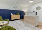 Thumbnail 12 of 24 - a living room with a blue and white rug and a reception desk