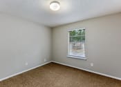 Thumbnail 21 of 24 - an empty bedroom with a window and a cork floor