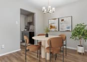 Thumbnail 4 of 24 - a dining room with a table and chairs