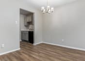 Thumbnail 19 of 24 - an empty living room with a kitchen in the background