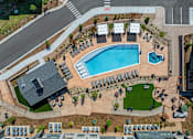 Thumbnail 51 of 58 - An aerial view of a swimming pool surrounded by lounge chairs and umbrellas.
