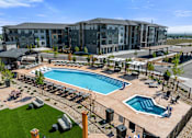 Thumbnail 54 of 58 - A large building with a pool in front.