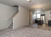 Thumbnail 8 of 17 - Carpeted room with staircase at The Village at Church & Main, Layton