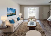 Thumbnail 3 of 11 - a living room with a couch a table and a television