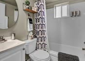Thumbnail 9 of 12 - a bathroom with a toilet and a tub and a sink