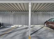Thumbnail 12 of 12 - a car parked in a parking garage with doors
