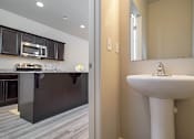 Thumbnail 7 of 17 - Bathroom with sink and mirror at The Village at Church & Main, Layton, Utah