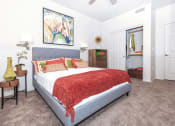 Thumbnail 14 of 23 - Queen sized Platform bed decorated with bright trendy throw pillows in large bedroom in 1x1 model apartment at Ascend at Red Mountain, Arizona
