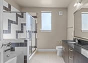 Thumbnail 10 of 23 - Modern bathroom with dual vanity and glass shower at Matilda at Lower Greenville Apartments, Dallas, TX