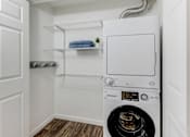 Thumbnail 18 of 18 - a small laundry room with a washer and dryer and a closet with shelves at Stonebridge, Phoenix, AZ, 85032