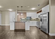 Thumbnail 5 of 23 - Open kitchen with island and stainless steel appliances at Matilda at Lower Greenville Apartments, Dallas