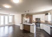 Thumbnail 6 of 23 - Open concept living and kitchen with dark wood flooring at Matilda at Lower Greenville Apartments, Dallas, Texas