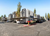 Thumbnail 27 of 29 - A parking lot with a fire hydrant and a building in the background.