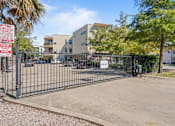 Thumbnail 18 of 23 - Gated parking lot entrance with security access at Matilda at Lower Greenville Apartments, Texas