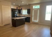 Thumbnail 14 of 14 - an empty kitchen with an island in the middle