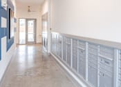 Thumbnail 24 of 25 - Mailroom hallway with resident mailboxes at Avion at West Lemmon Apartments, Dallas, Texas