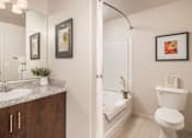 Thumbnail 8 of 25 - A bathroom with a white toilet and a white sink.