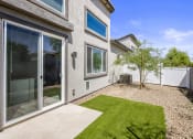 Thumbnail 17 of 29 - a backyard with a grassy area and a patio with a tree