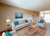 Thumbnail 7 of 11 - a living room with a couch and a table