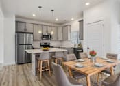 Thumbnail 4 of 22 - a kitchen and dining room with stainless steel appliances