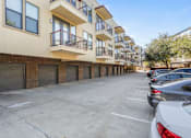 Thumbnail 16 of 23 - Ground level parking lot with private garage access at Matilda at Lower Greenville Apartments, Dallas, TX 75206