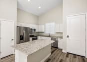 Thumbnail 15 of 29 - Linq at south mountain kitchen with white island and stainless steel appliances