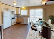 Thumbnail 9 of 11 - a kitchen and dining room with a table and chairs