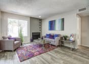 Thumbnail 8 of 25 - a living room with couches and chairs and a rug