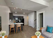 Thumbnail 2 of 14 - a living room and kitchen with a couch and