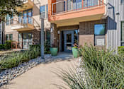Thumbnail 17 of 23 - Apartment community entrance with landscaped walkway at Matilda at Lower Greenville Apartments, Dallas, TX 75206