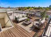 Thumbnail 3 of 25 - Rooftop terrace with seating and dining areas at Avion at West Lemmon Apartments, Dallas, TX