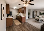Thumbnail 5 of 22 - A modern kitchen with wooden cabinets and a ceiling fan.