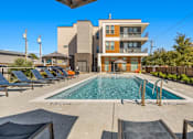 Thumbnail 14 of 25 - Resort style pool with lounge seating at Avion at West Lemmon Apartments, Texas