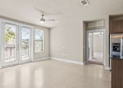 Thumbnail 7 of 23 - Bright living room with french doors and ceiling fan at Matilda at Lower Greenville Apartments, Dallas, TX 75206