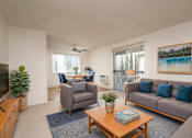Thumbnail 5 of 19 - a living room with a couch and a coffee table