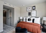 Thumbnail 20 of 28 - A bedroom with a bed, nightstands, and a chair.