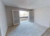 Thumbnail 15 of 18 - an empty living room with a window and a door to a balcony at Stonebridge, Arizona, 85032