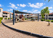 Thumbnail 14 of 23 - Community playground with shade canopy and sand surface at Gentrys Walk Apartments, Mesa, 85204