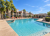 Thumbnail 22 of 23 - Resort style pool with lounge chairs and spa at Gentrys Walk Apartments, Mesa, AZ 85204