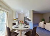 Thumbnail 5 of 12 - A dining room with a table set for two and chairs around it.