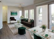 Thumbnail 6 of 26 - a living room and dining room with a table and chairs