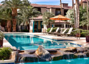 Thumbnail 7 of 26 - resort-style  surrounded by poolside chaise lounge chairs, large palm trees