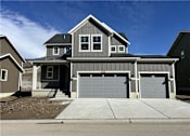 Thumbnail 1 of 28 - A two-story house with a garage is shown.