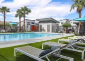 Thumbnail 1 of 29 - a swimming pool with lounge chairs and palm trees