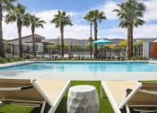 Thumbnail 2 of 29 - a swimming pool with palm trees and houses in the background