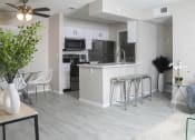 Thumbnail 5 of 25 - an open kitchen and living room with a bar and stools